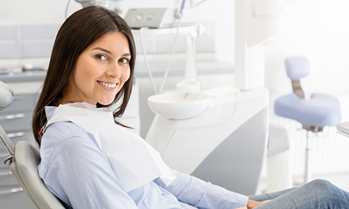 A woman sitting in a dentist chair